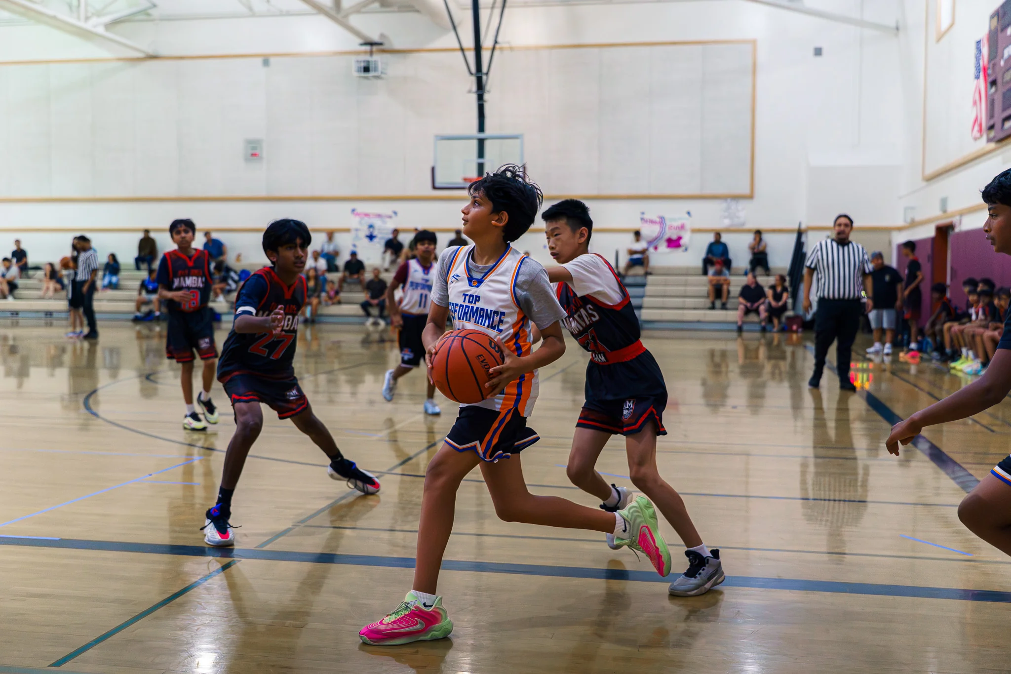 A TPB player drives toward the basket during an October tournament game